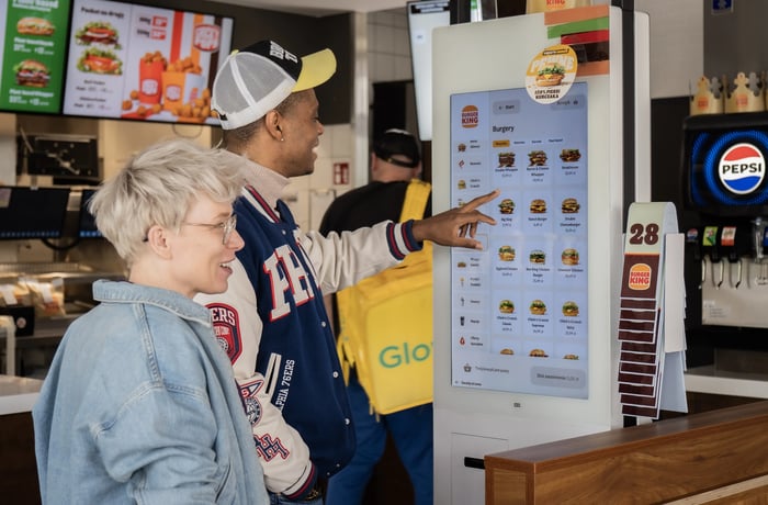 Guests ordering at an Ordering Stack self-service kiosk in a Burger King restaurant