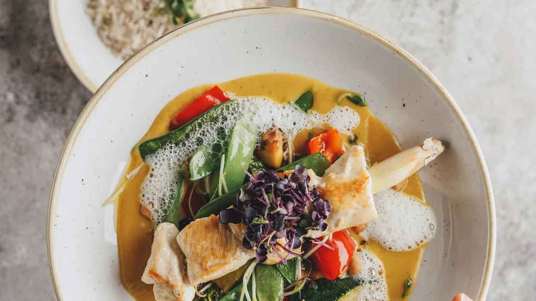 Fischgericht mit Gemüse, Kokosschaum und Kresse in Currysauce