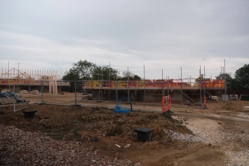 Multiple plots progressing through different building stages at Deepdale Drive