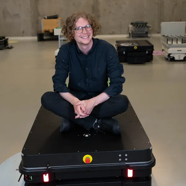 Zachary Aagesen sidder på robot fra MiR | NovuStella - Hjemmesider i Nyborg