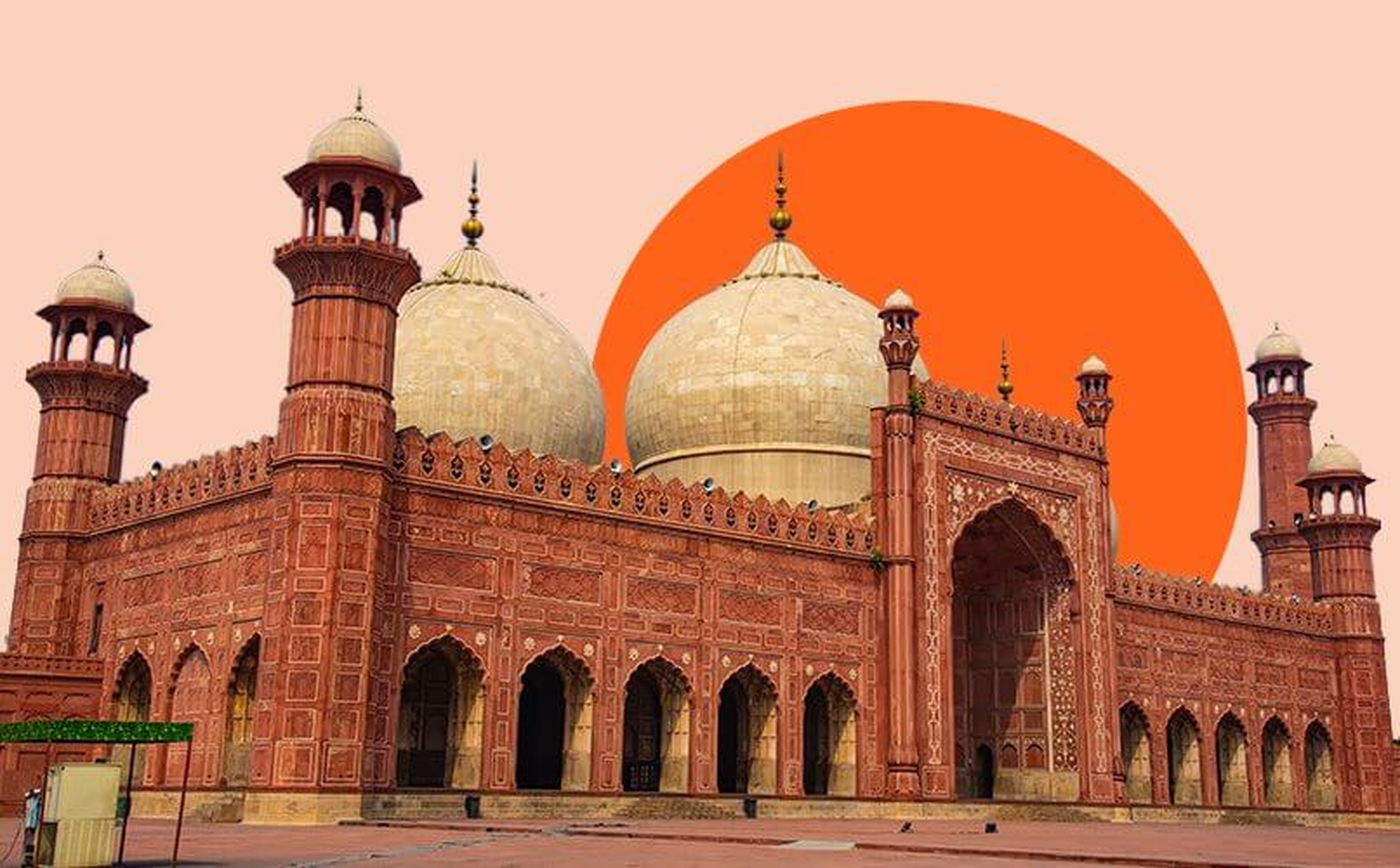 A grand, red sandstone mosque with three large white domes and intricately carved archways stands in front of a pale pink sky. A large, solid orange circle partially overlaps the background, creating an eye-catching contrast. The mosque has multiple minarets.