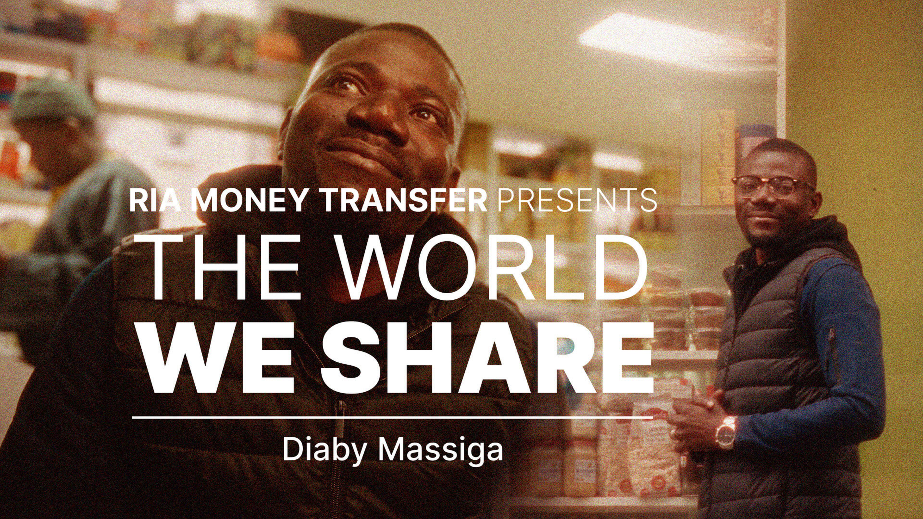 A promotional image featuring a man smiling in two different settings, with bold text reading "RIA Money Transfer Presents The World We Share" and the name "Diaby Massiga" at the bottom. Shelves with products are visible in the background.