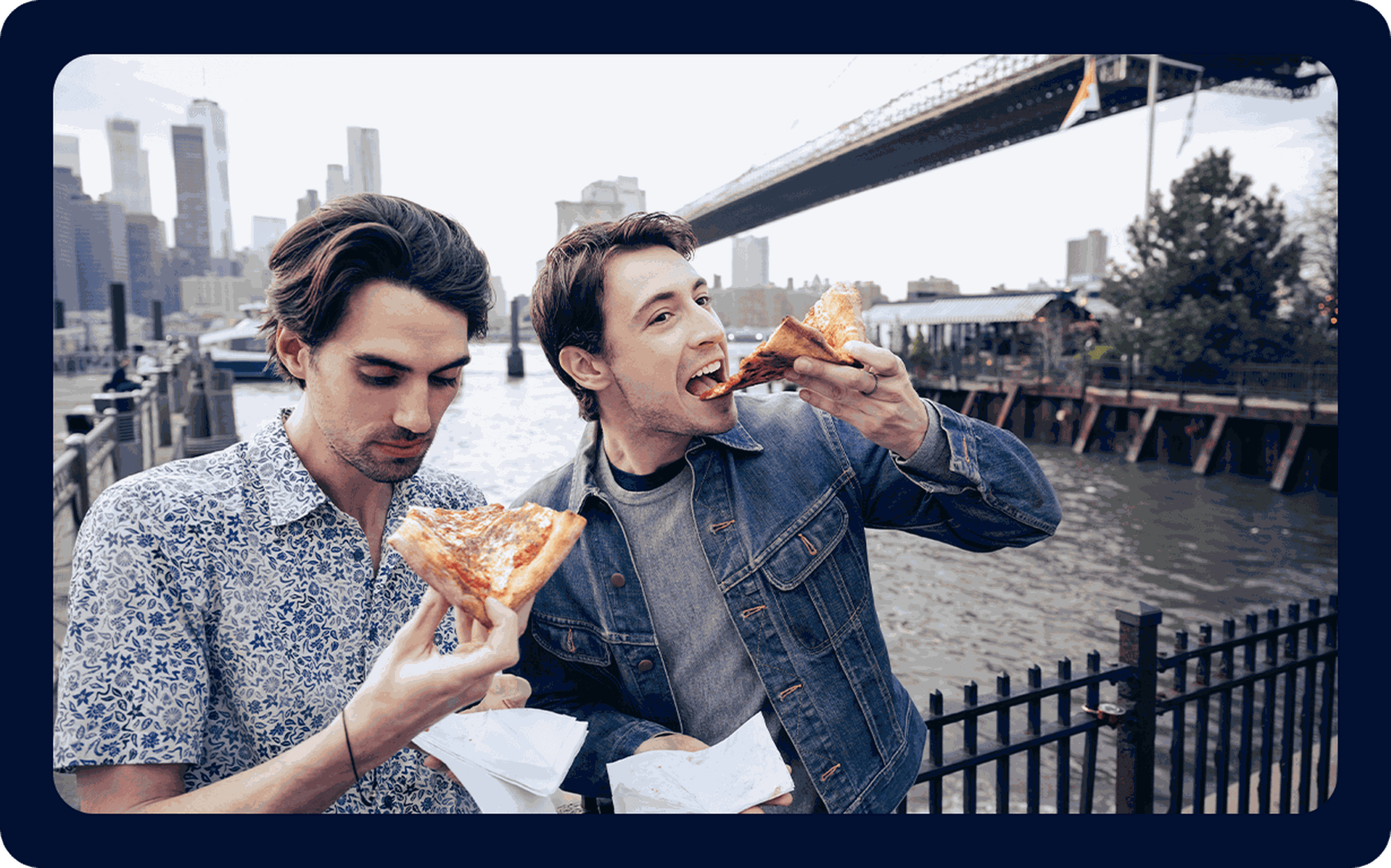 Two men eating pizza in a U.S. city