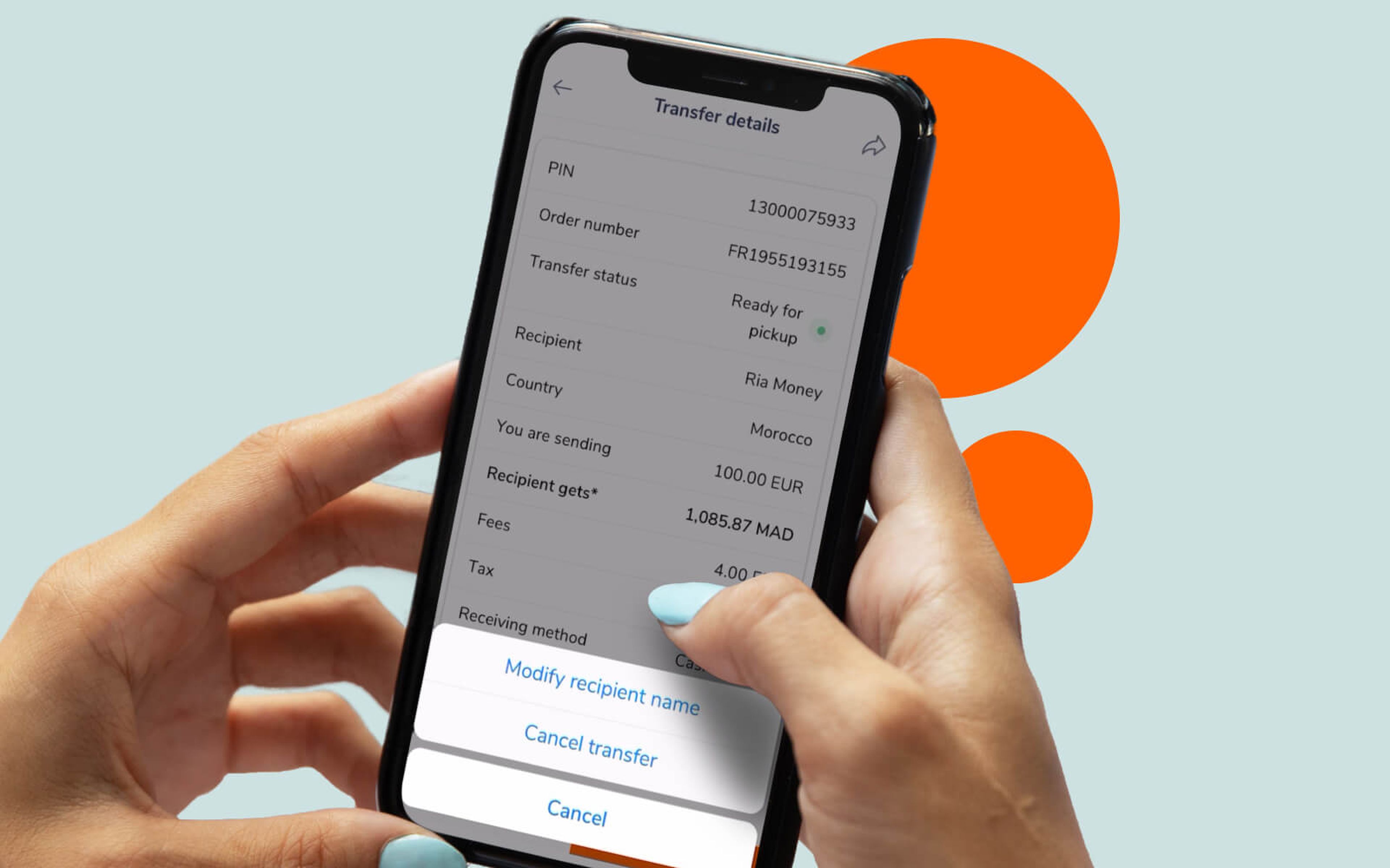 A person holds a smartphone displaying transfer details on the screen. The information includes a PIN, order number, transfer status, recipient, country, sending amount, recipient gets amount, fees, and tax. Options at the bottom include modifying recipient name and canceling transfer.