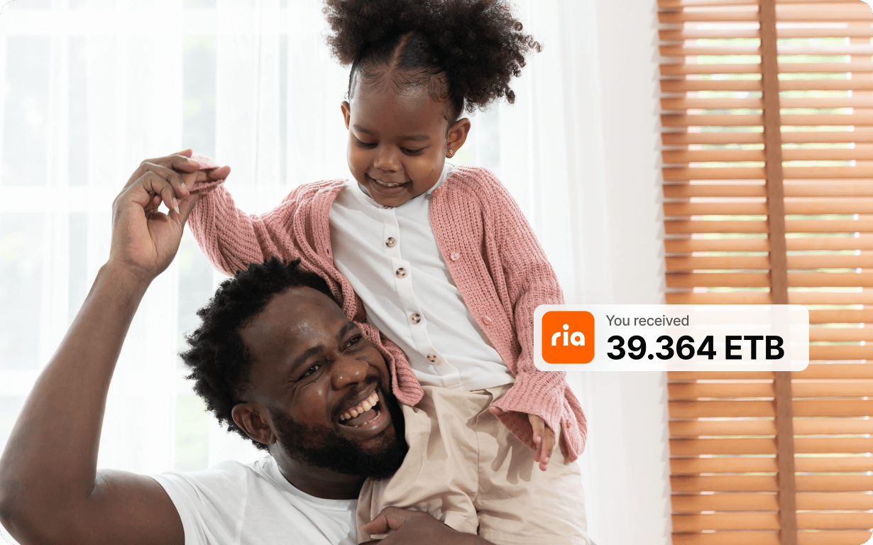 A smiling man lifts a happy young girl onto his shoulders inside a bright room. A notification overlay shows "You received 39.364 ETB" with the Ria logo.