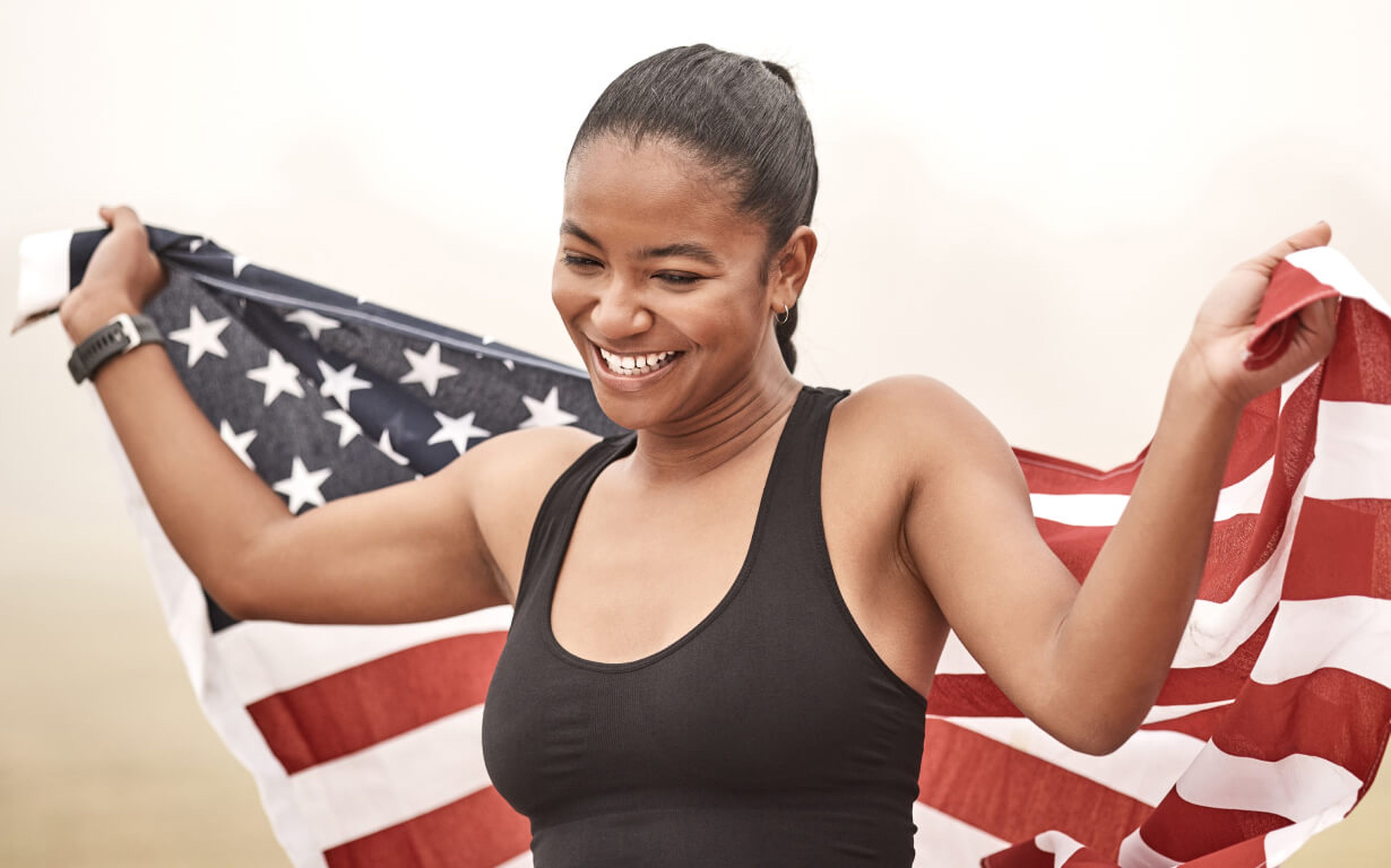 Latin American woman with a flag from the U.S. on her way to getting financially established