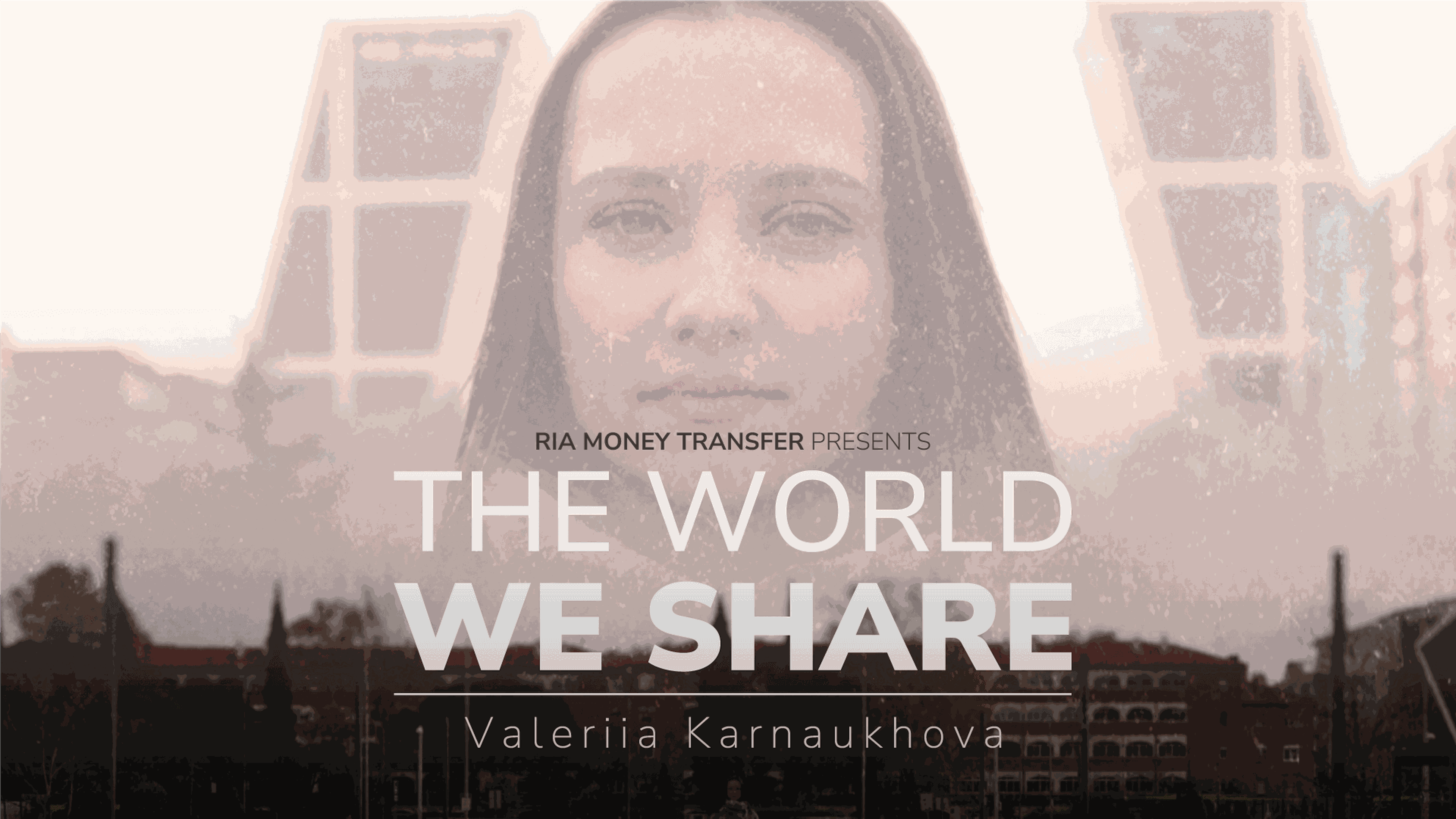 A poster featuring a woman with a serious expression in the center. Text overlaid on the image reads, "RIA Money Transfer Presents The World We Share" with "Valeriia Karnaukhova" written underneath. The backdrop includes modern buildings and a cityscape.