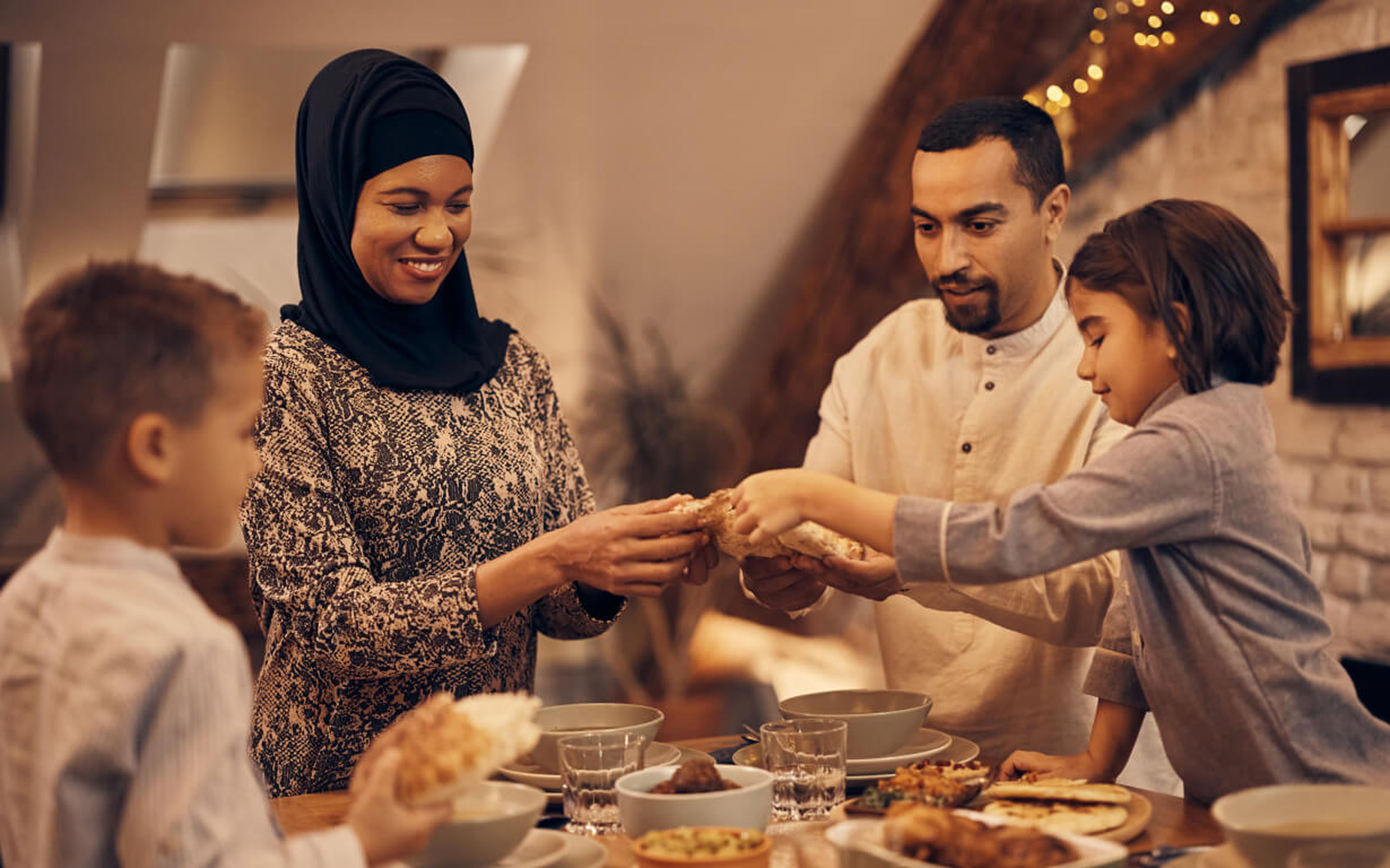 Muslim family sharing a meal.