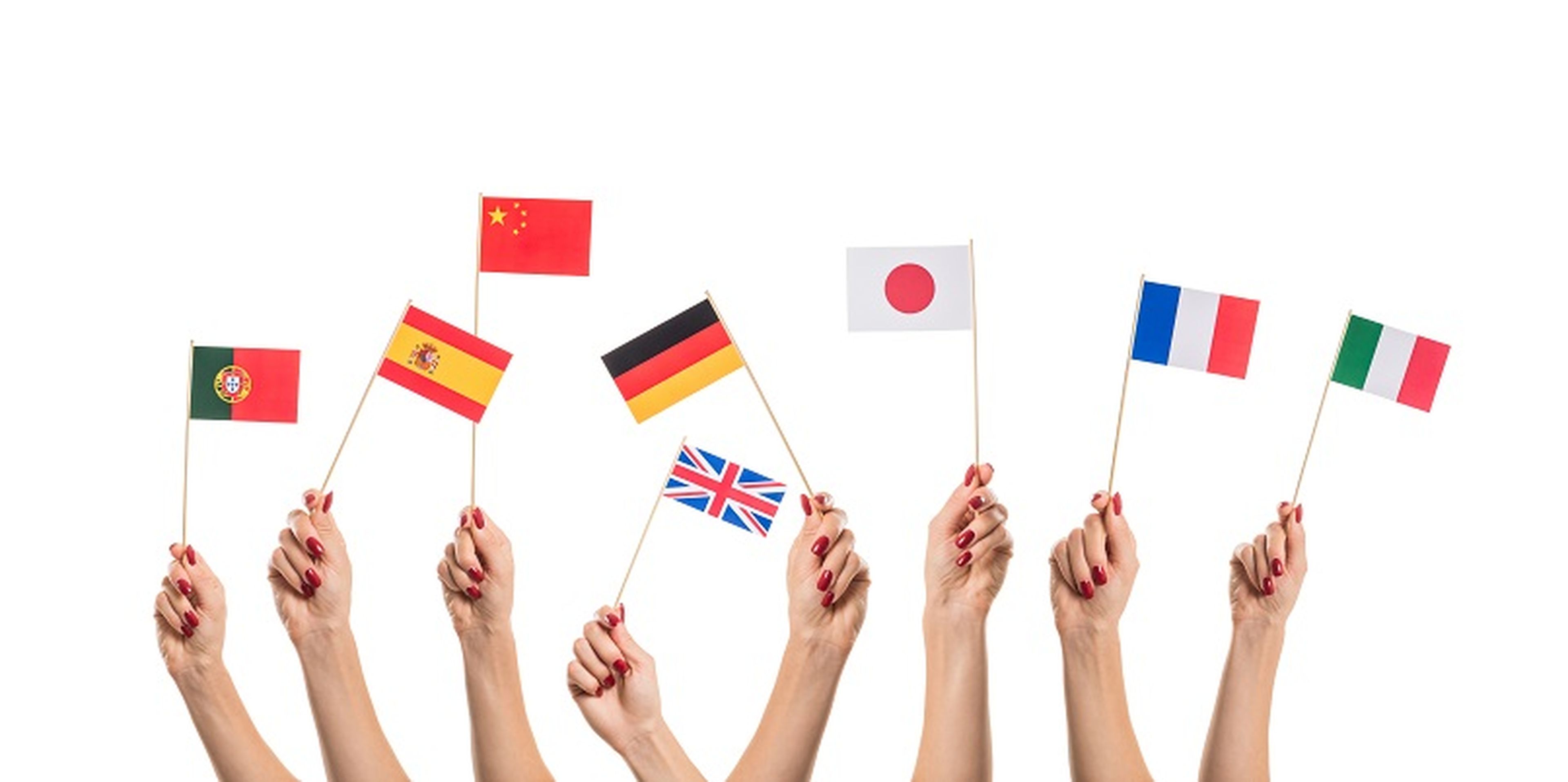 National flags of Germany, England, Italia, Japan, China Spain, France, Portugal in hands. Language studying concept on white background