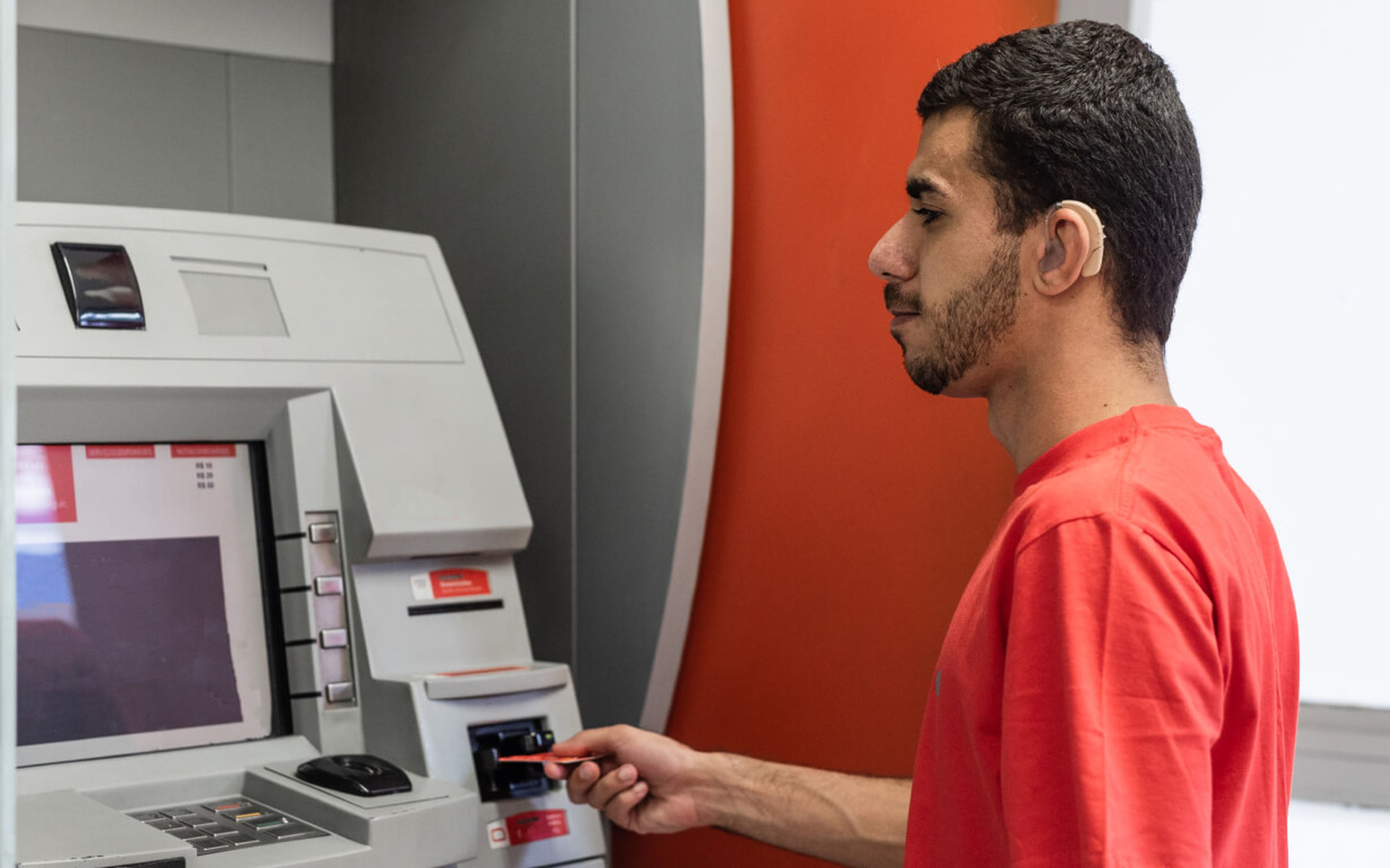 Latin American man at an ATM