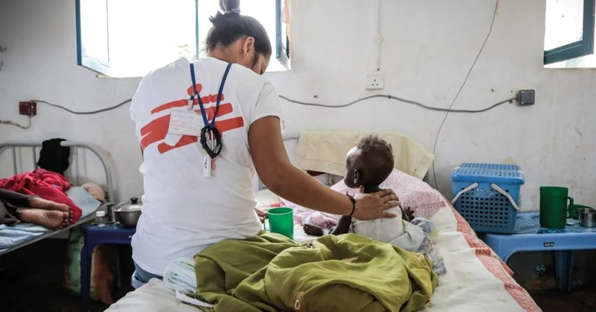 Doctors Without Borders nurse caring for a child in a hospital ward