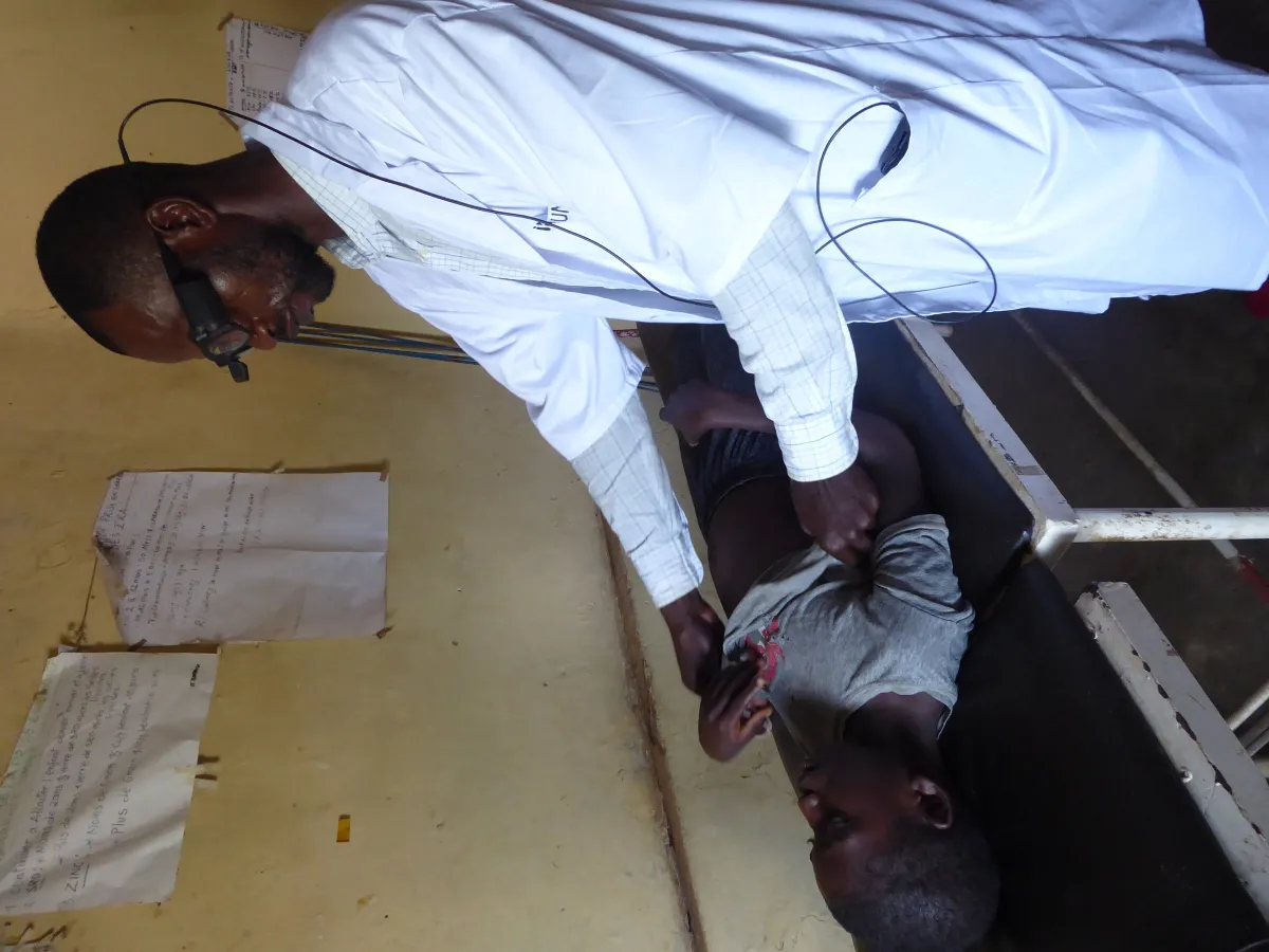 Nurse with smart glasses examining a patient during a teleconsultation