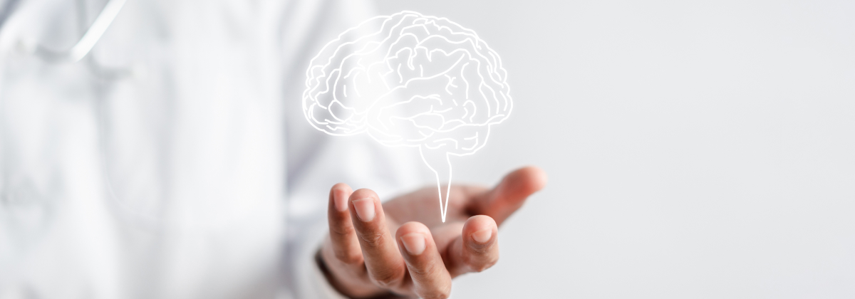 Medical professional holding a glowing illustration of the human brain