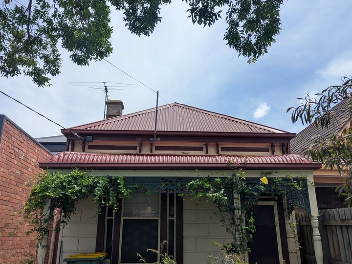 The same cottage roof after cleaning, rust treatment and new coats
