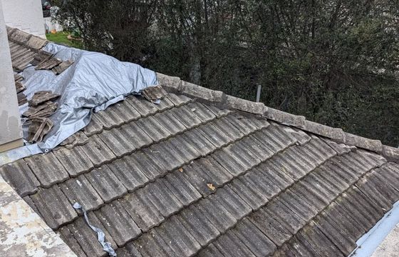 Weathered and broken concrete roof tiles before repair