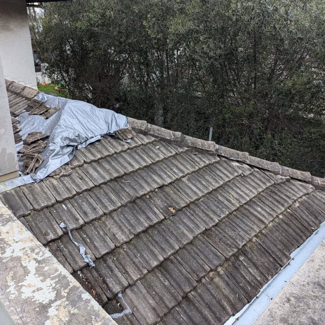 Weathered and broken concrete roof tiles before repair