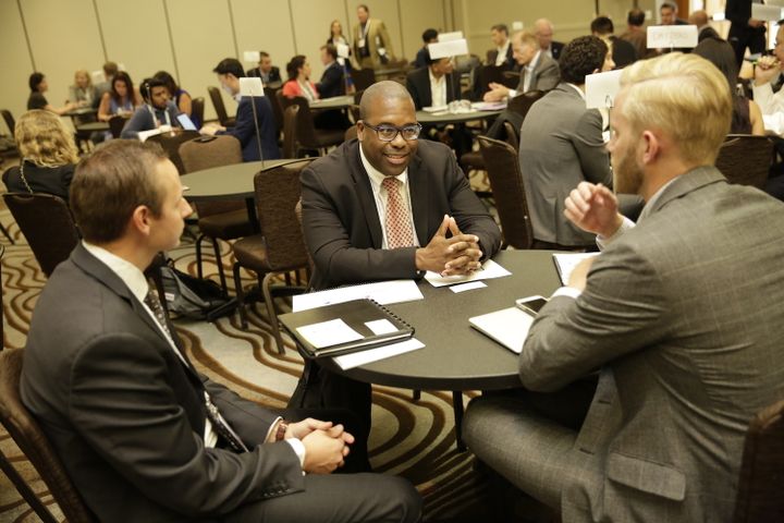 Attendees in a one-on-one meeting at a round table during the 2017 MedTech Innovator finals