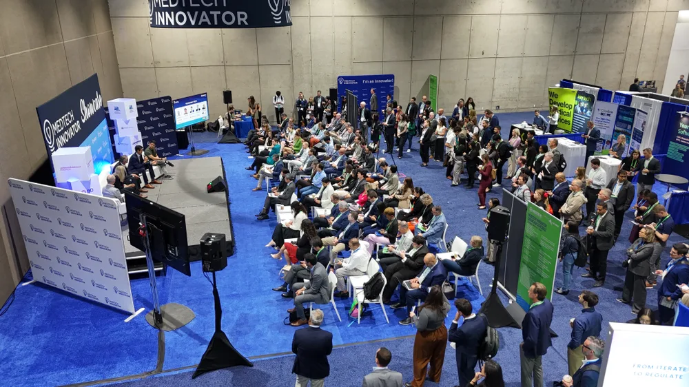A packed MedTech Innovator Showcase panel session on the exhibit floor, seen from above