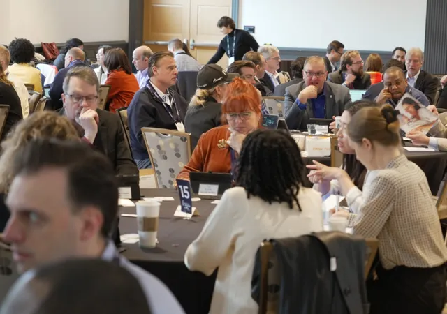 People at round tables at an MTI pitch event
