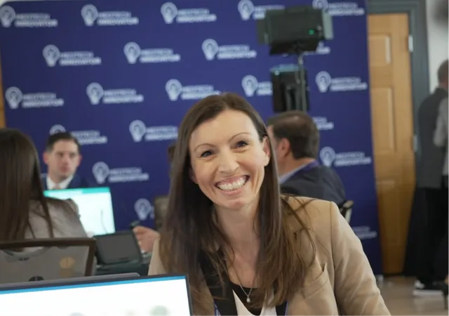 A woman listening at an MTI pitch event