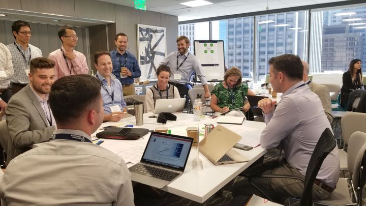 MedTech Innovator 2018 Summit participants working around a table in a value workshop