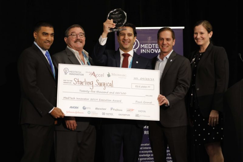 Starling Surgical receiving the MedTech Innovator 2019 Execution Award check and trophy on stage
