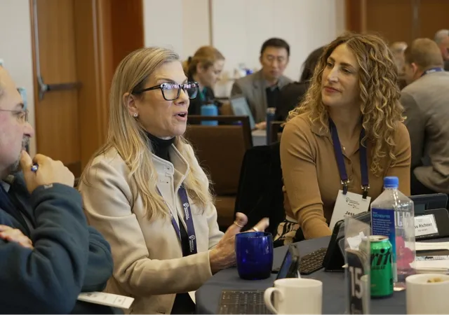 Two women in conversation at an MTI pitch event