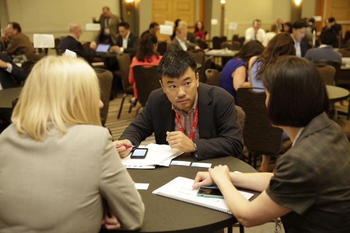 Attendees in one-on-one partnering meetings at round tables at The MedTech Conference 2017