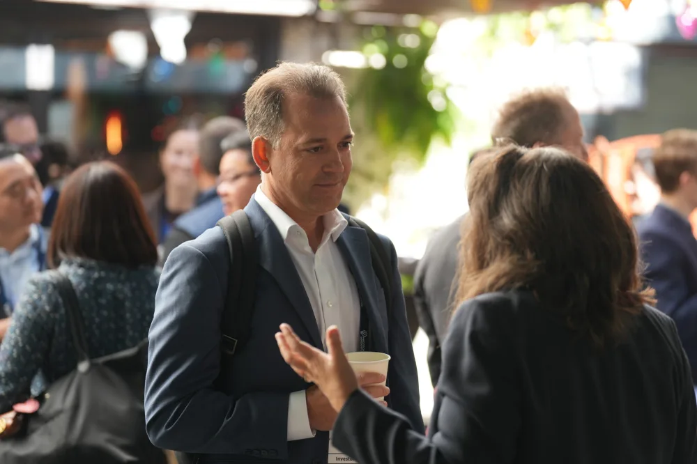 An investor in conversation with an attendee at a MedTech Innovator networking event