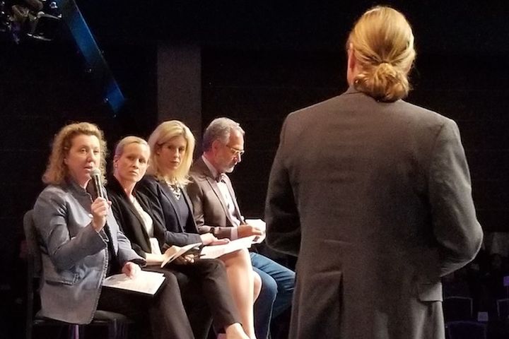 Panel of judges questioning a presenter at a MedTech Innovator pitch event