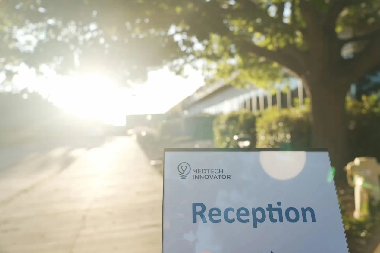 A MedTech Innovator reception sign outside an event venue at sunset