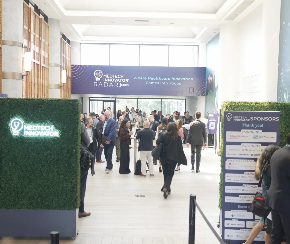 Attendees mingling in the lobby beneath the MedTech Innovator Radar Forum banner