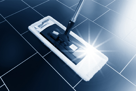 Flachmopp auf dunklem Fliesenboden