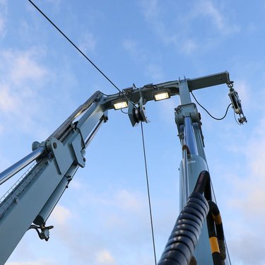 View an a-frame with umbrilical and lights against a blue sky with scattered clouds
