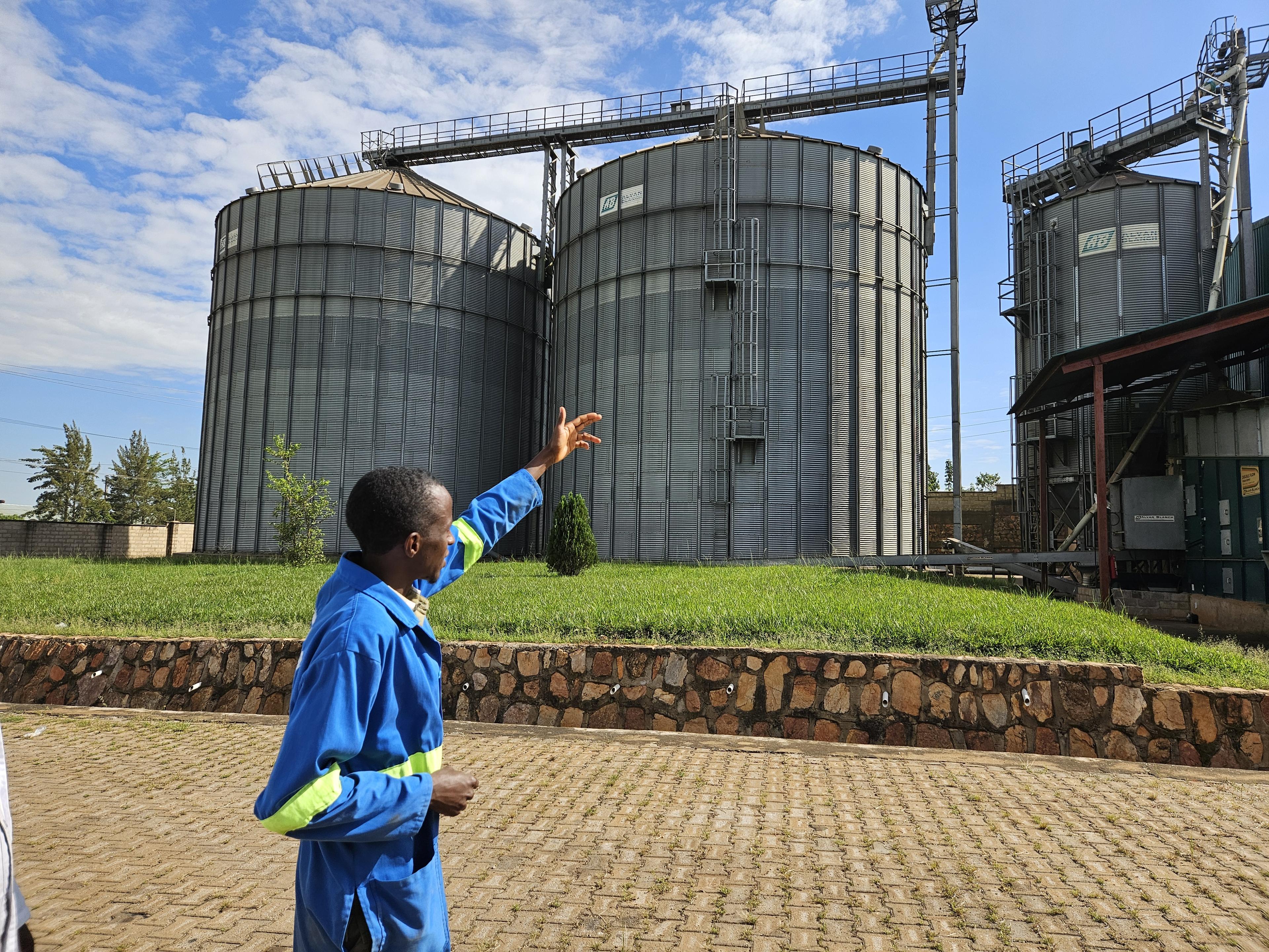 Man pointing to corn storage cilos
