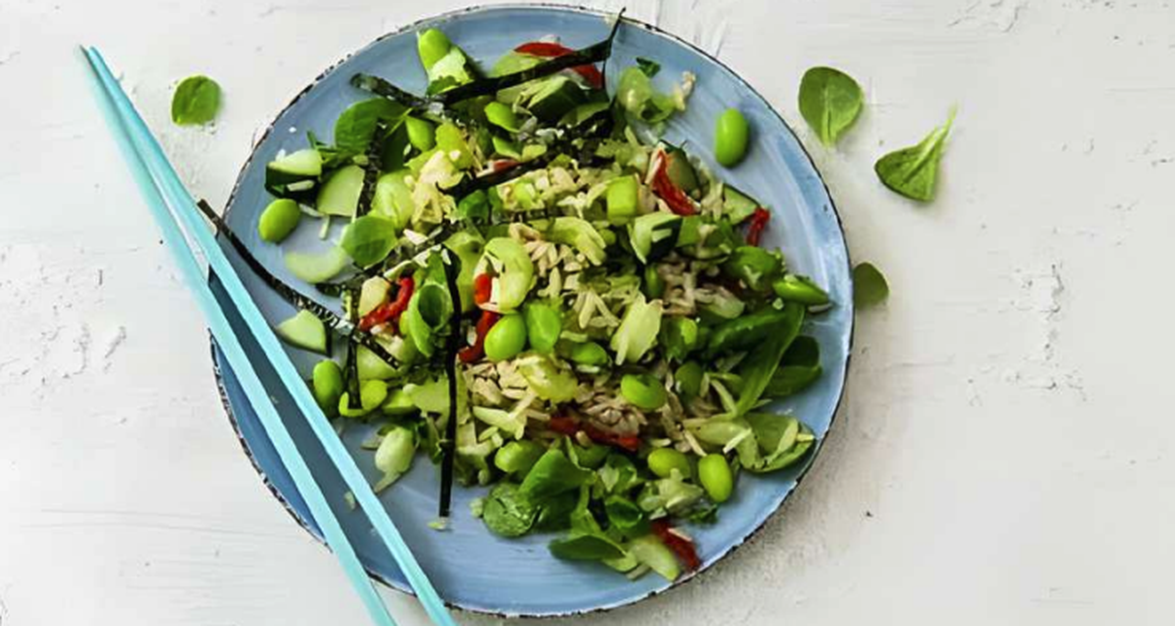 blauw bord met een salade en blauwe stokjes