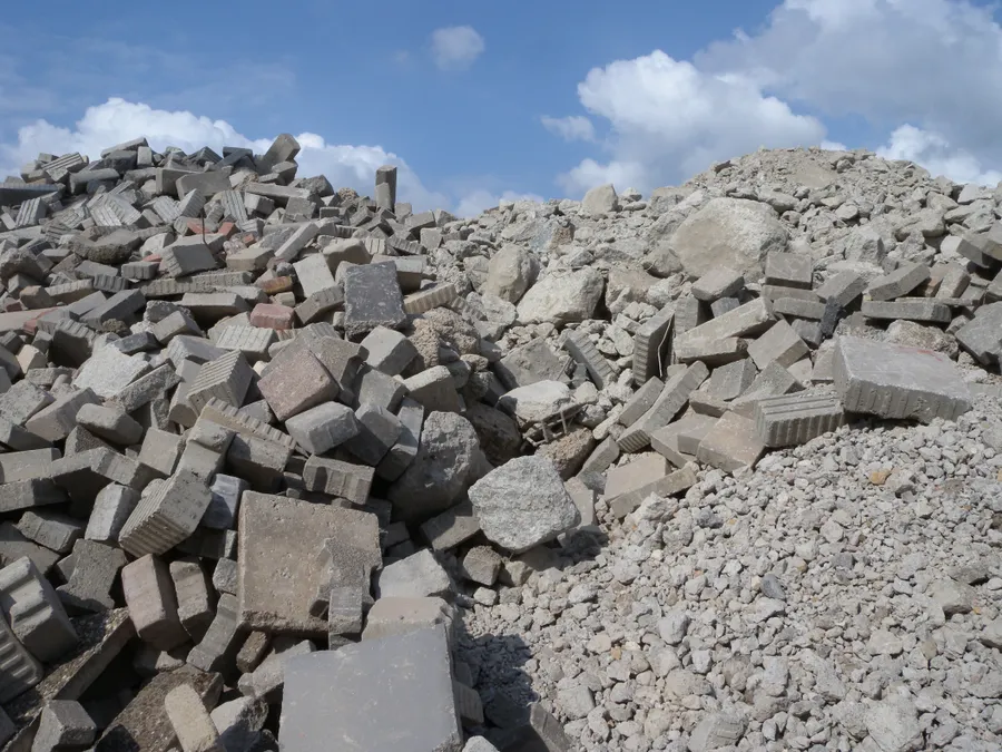 Pile of broken concrete and demolition rubble ready for processing.