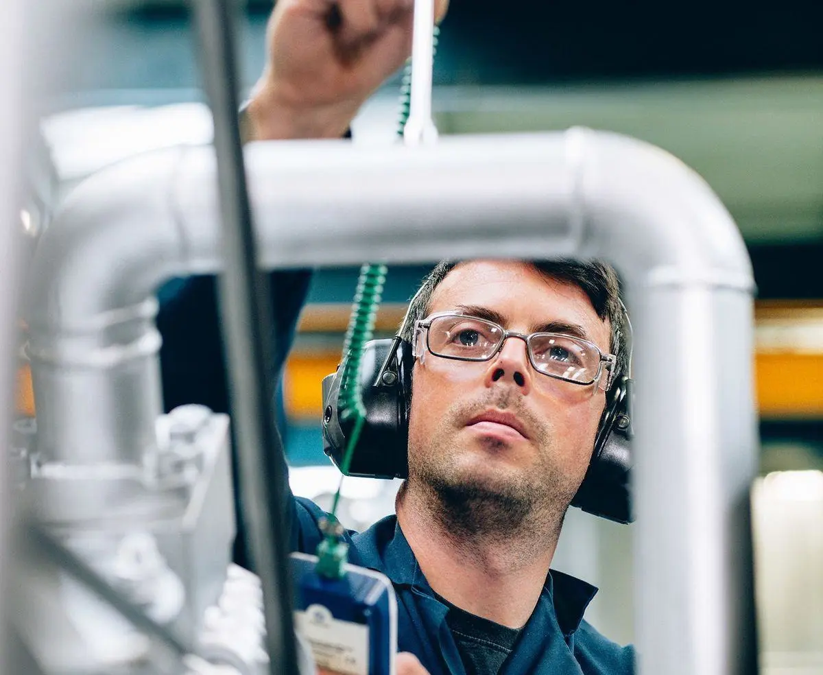 Technician inspecting machinery