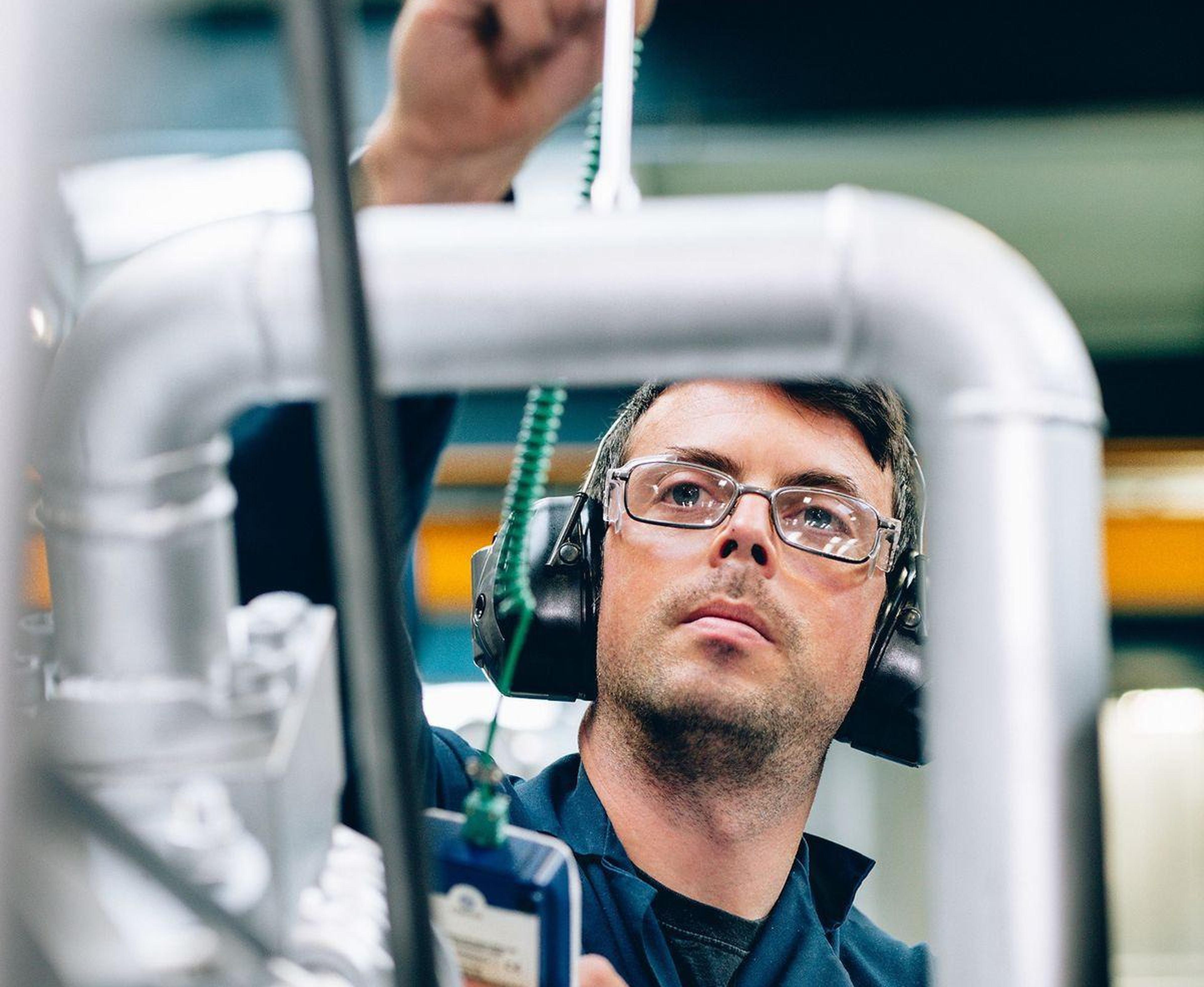 Technician inspecting machinery