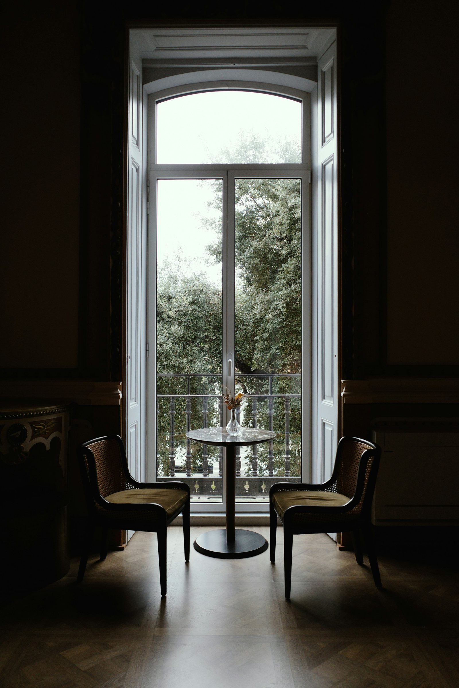 A tall French window with a small table for two.