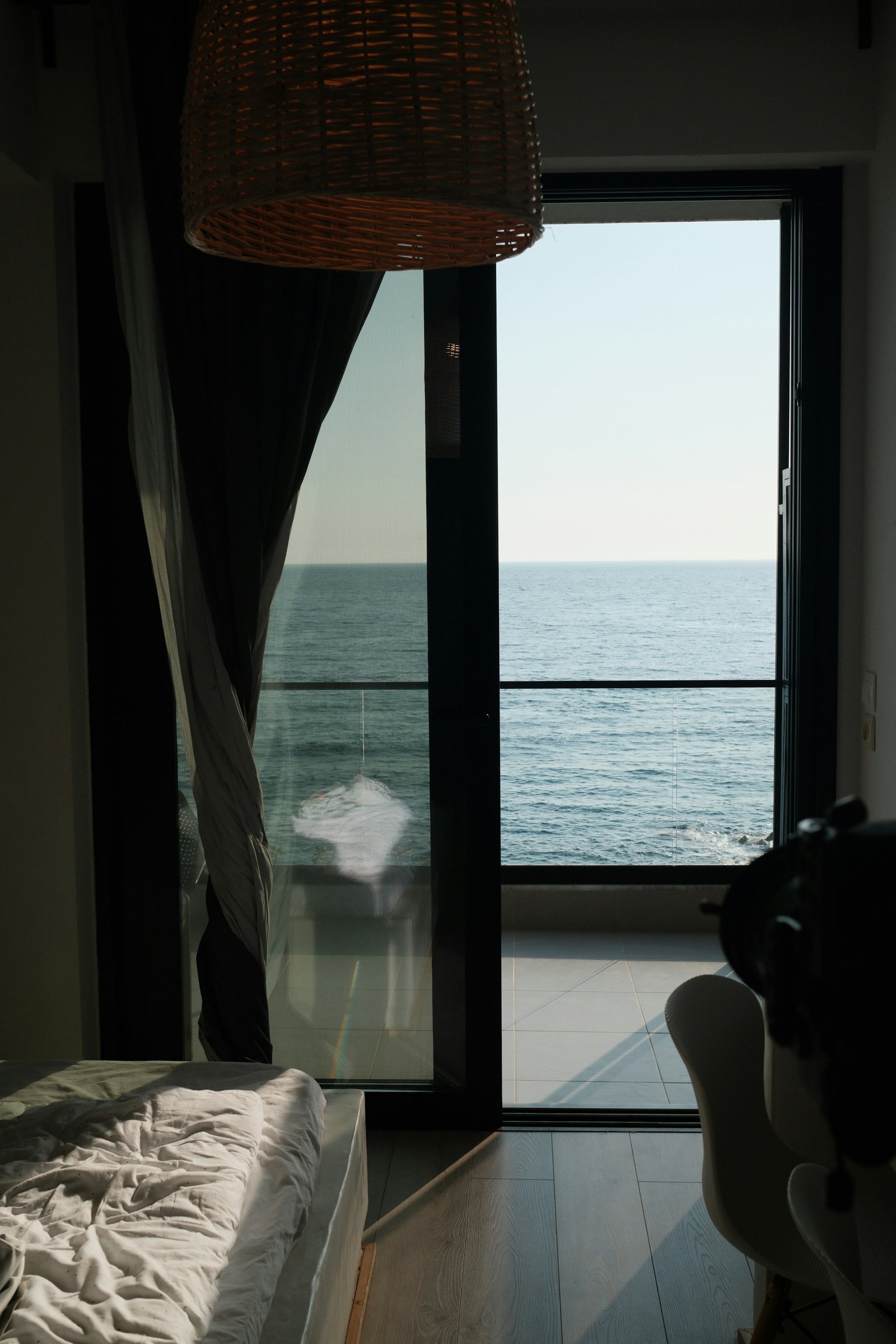 A quiet bedroom doorway opening straight onto the sea.