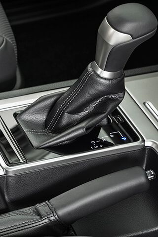 Close-up image of a gear stick in a modern rental car