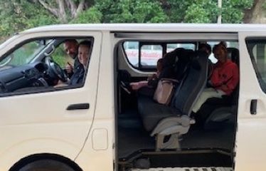 People sitting inside a white van with the sliding door open