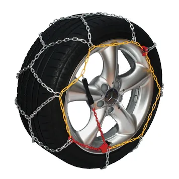 Snow chain fitted over the tyre and alloy wheel of a car, shown against a white background