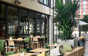 Outdoor seating area with greenery at Sudima Hotel Christchurch City