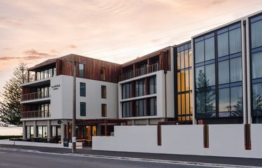 Exterior view of Sudima Kaikōura hotel at sunset with ocean glimpses and modern design