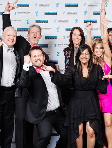 Image of the GO Rentals team celebrating with an award at the 2degrees Auckland Business Awards