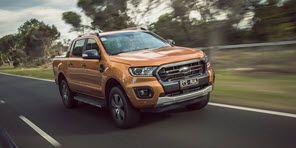 Image of an orange Ford Ranger driving on an open road