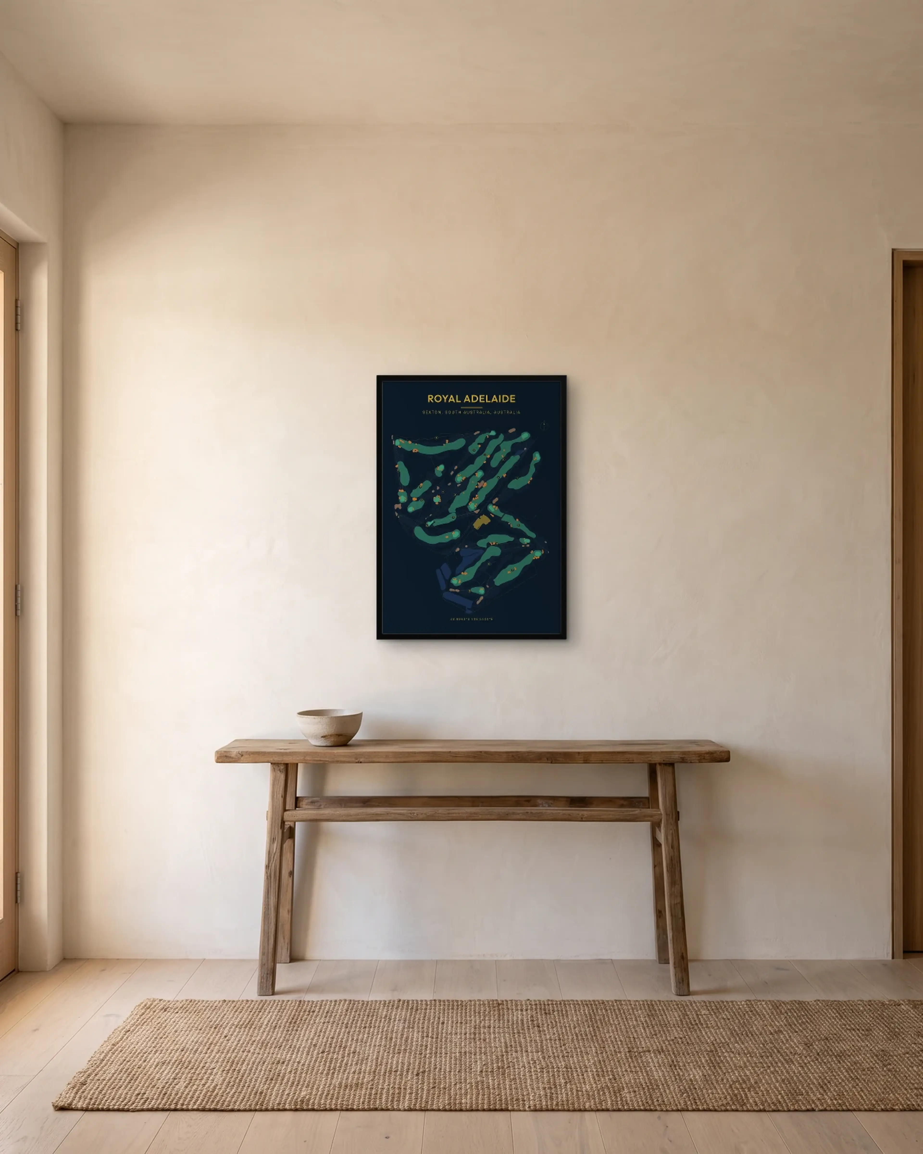 A navy Royal Adelaide print hung at eye level in a hallway