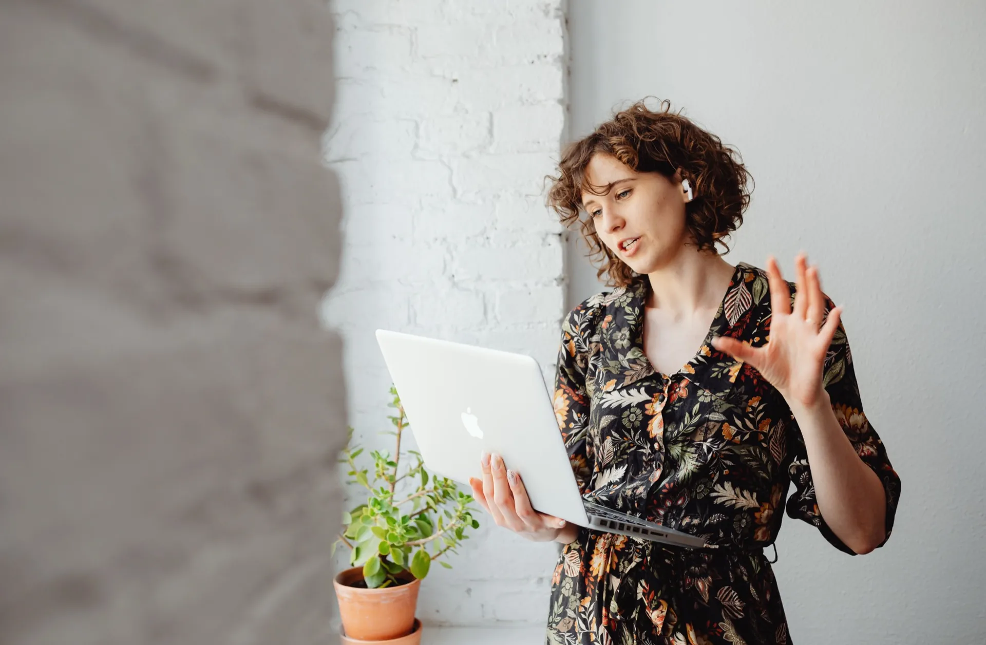 A woman gesturing as she speaks during a video call